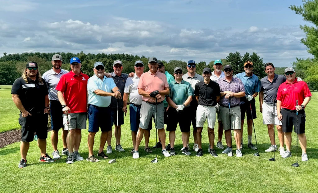 A group of male golfers gathered for a picture.